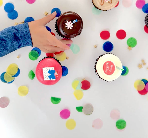 Holiday cupcake collection banner with a pink winter background