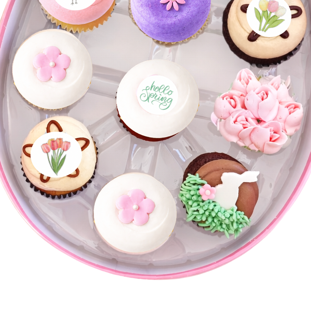 Spring cupcakes with flowers, butterflies, and pastel icing in egg-shaped box