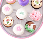 Spring cupcakes with flowers, butterflies, and pastel icing in egg-shaped box