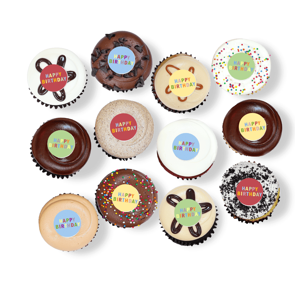 Cupcakes with colorful “Happy Birthday” toppers and sprinkles