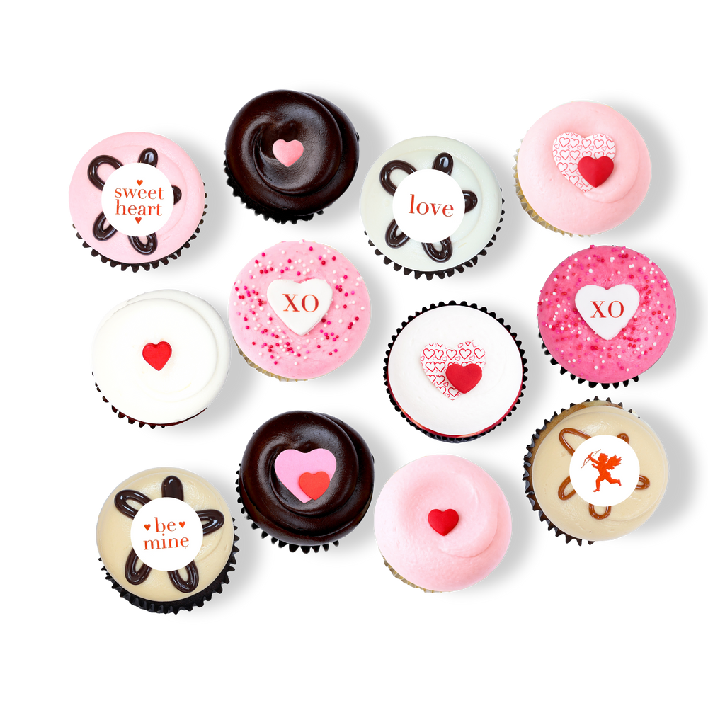 Valentine’s cupcakes with pink, white, and chocolate frosting and “XO” and “love” messages