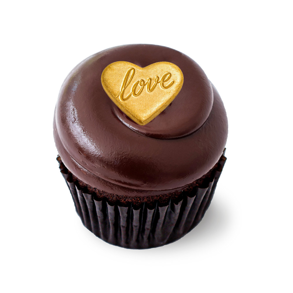 Chocolate cheesecake cupcake with chocolate frosting and gold heart topper