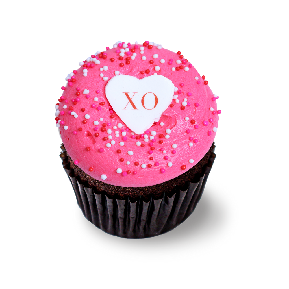 Chocolate cupcake with pink buttercream and XO topper