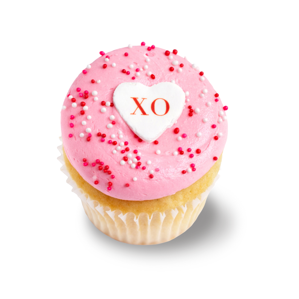 Vanilla cupcake with pink buttercream, sprinkles, and XO topper