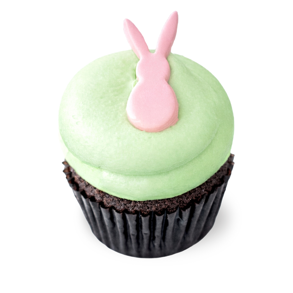 Chocolate cupcake with green frosting and pink bunny topper