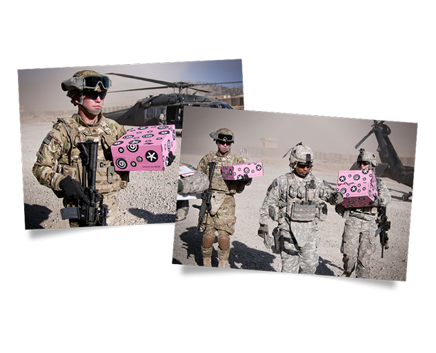 Service members carrying pink boxed packages during a delivery operation