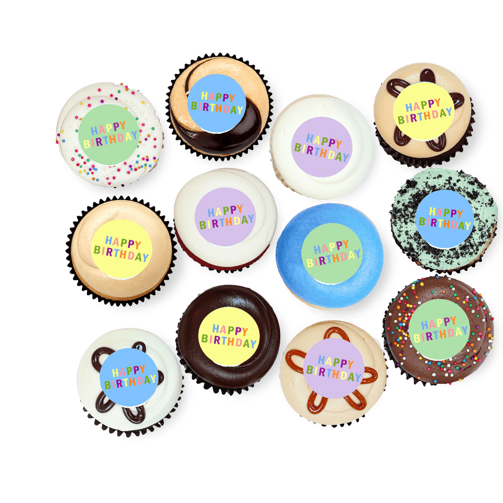 Cupcakes with colorful “Happy Birthday” toppers in varied frosting styles