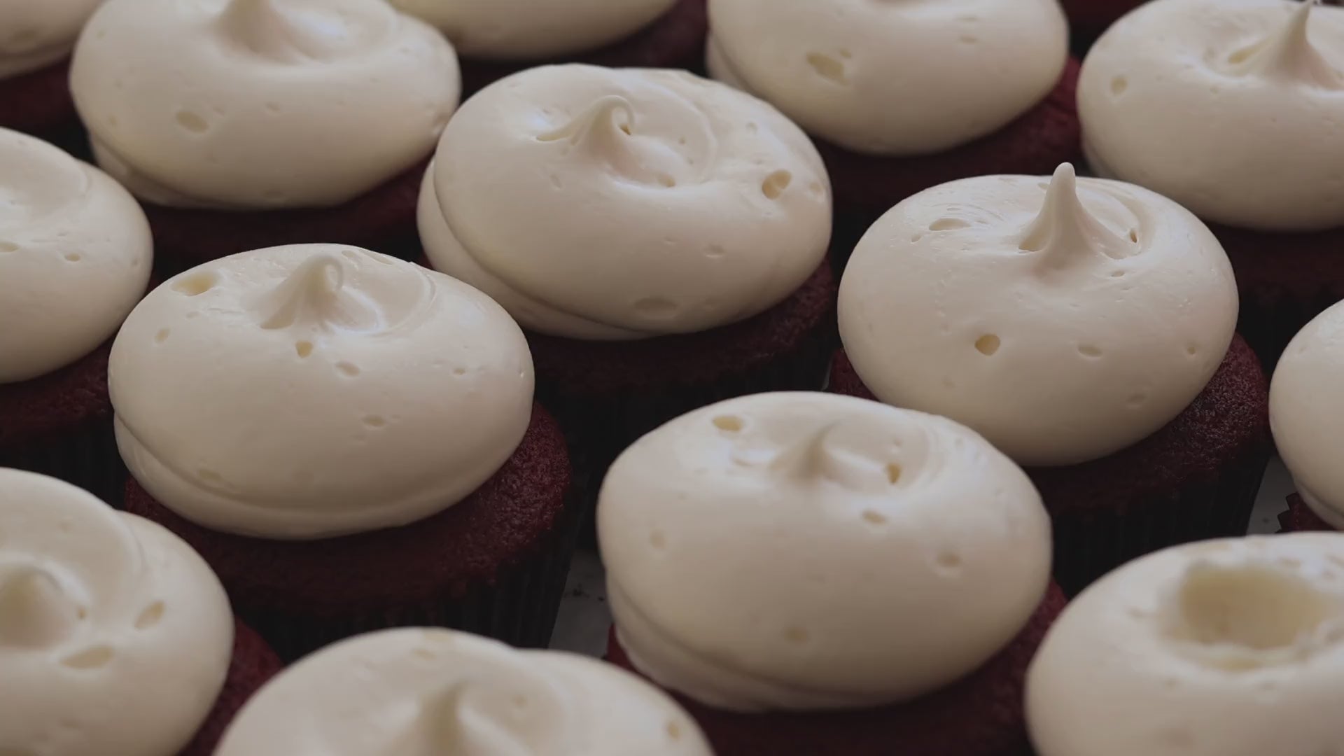 Red velvet cupcakes topped with smooth cream cheese frosting